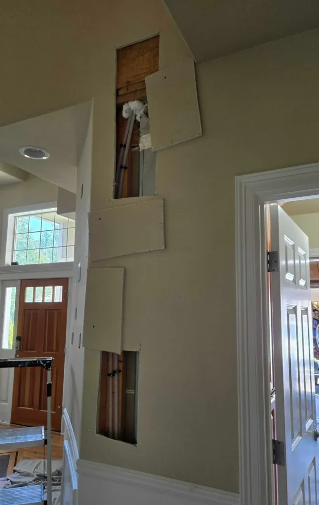 Express Repiping professionals at work, installing flexible PEX piping in a residential home.