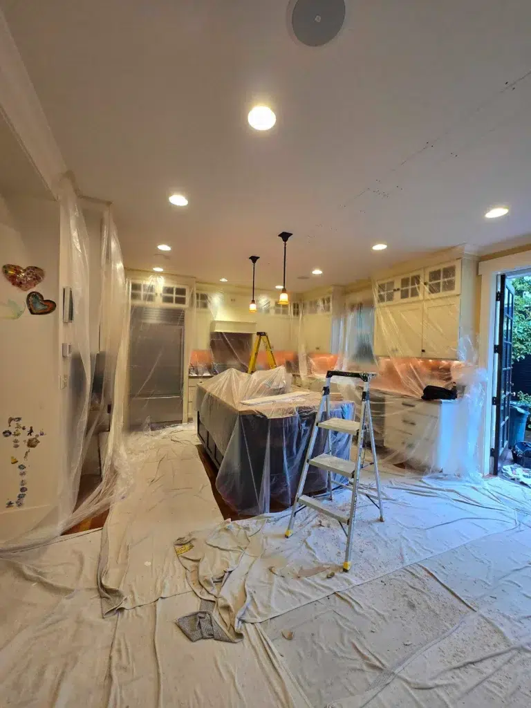 Professional whole house repipe Seattle kitchen showing new PEX piping installation protected with canvas barriers and dust containment—demonstrating Express Repiping's careful, clean project standards.